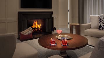 A living room with a fireplace, a round coffee table, and a sofa.