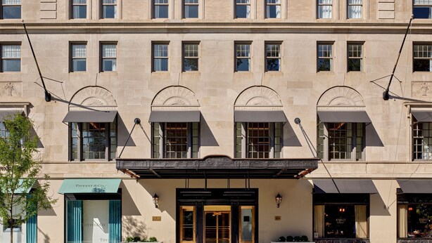A multi-story building with a classic architectural style, featuring large windows and a prominent entrance with a canopy.