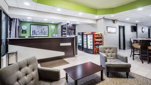 A lobby with a reception desk, seating area, and a refrigerator stocked with beverages. - Super 8 by Wyndham Knoxville West/Farragut (Knoxville)