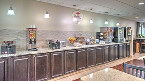 A breakfast bar with a coffee machine, toaster, and fruit bowl. - Super 8 by Wyndham Knoxville West/Farragut (Knoxville)