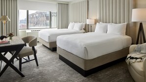 A hotel room with two beds, a desk, and a chair. - Capitol Hill Hotel (Washington)