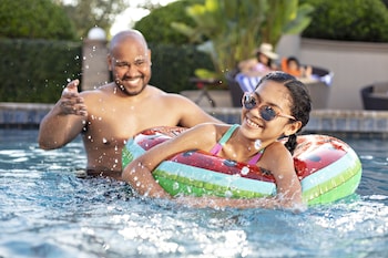Outdoor pool, open 8:00 AM to 11:00 PM, pool umbrellas, sun loungers at Buena Vista Suites Orlando
