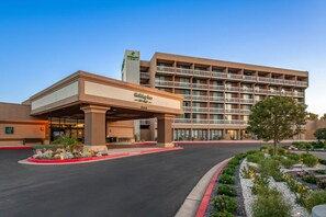 A Holiday Inn Express hotel with a modern design, featuring a covered entrance and multiple balconies.
