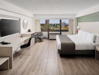 In-room safe, desk, laptop workspace, blackout drapes at Wyndham I-Drive Avanti Resort & Conference Center