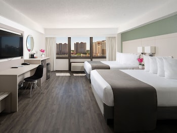 In-room safe, desk, laptop workspace, blackout drapes at Avanti Palms Resort and Conference Center