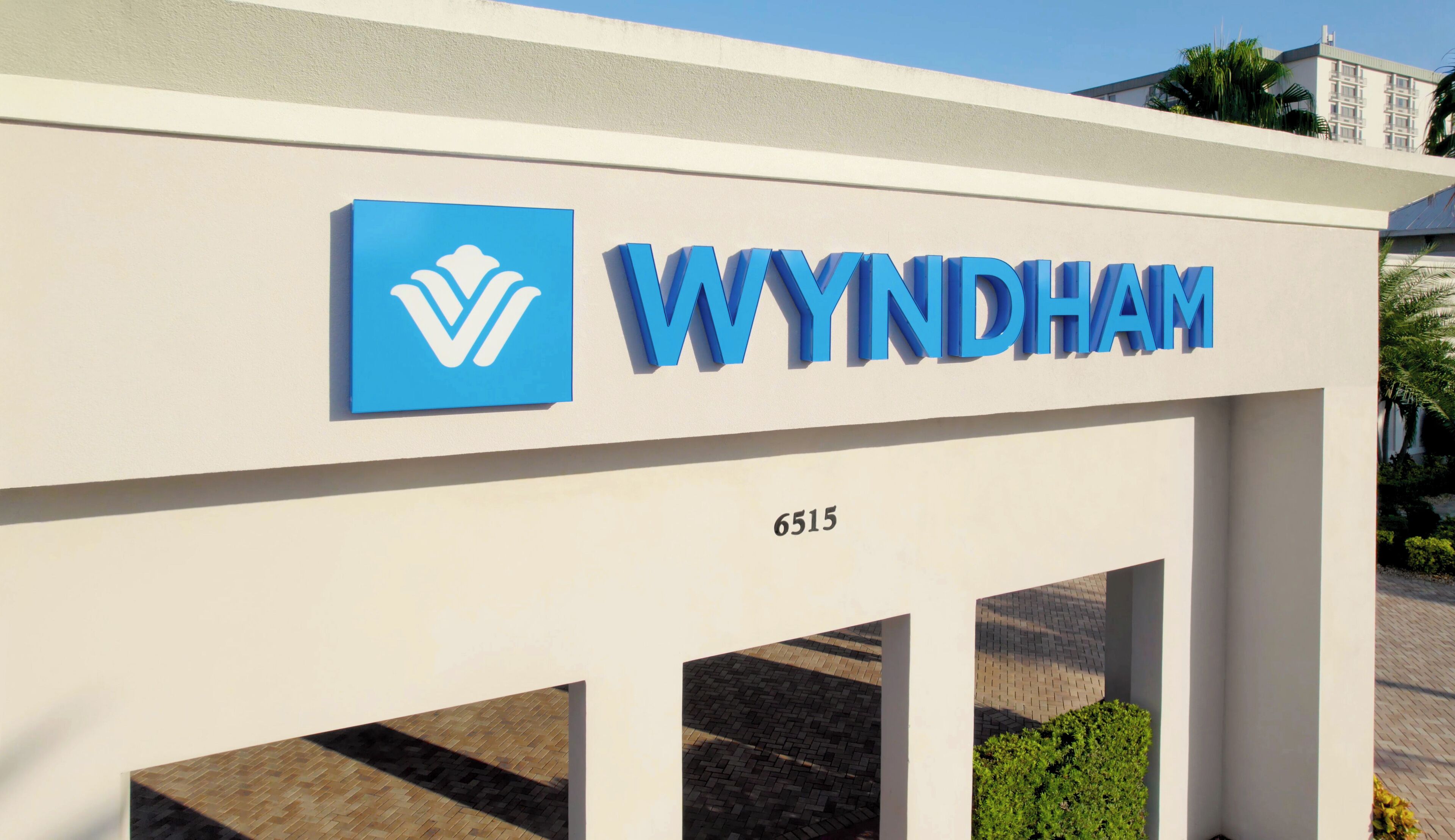 A building with a sign that reads "WYNDHAM" and a number "6515" below it.