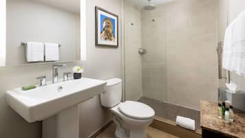 A modern bathroom with a sink, toilet, and shower.