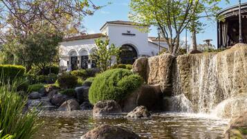 A building labeled "Crossroads" with a waterfall, rocks, and greenery.