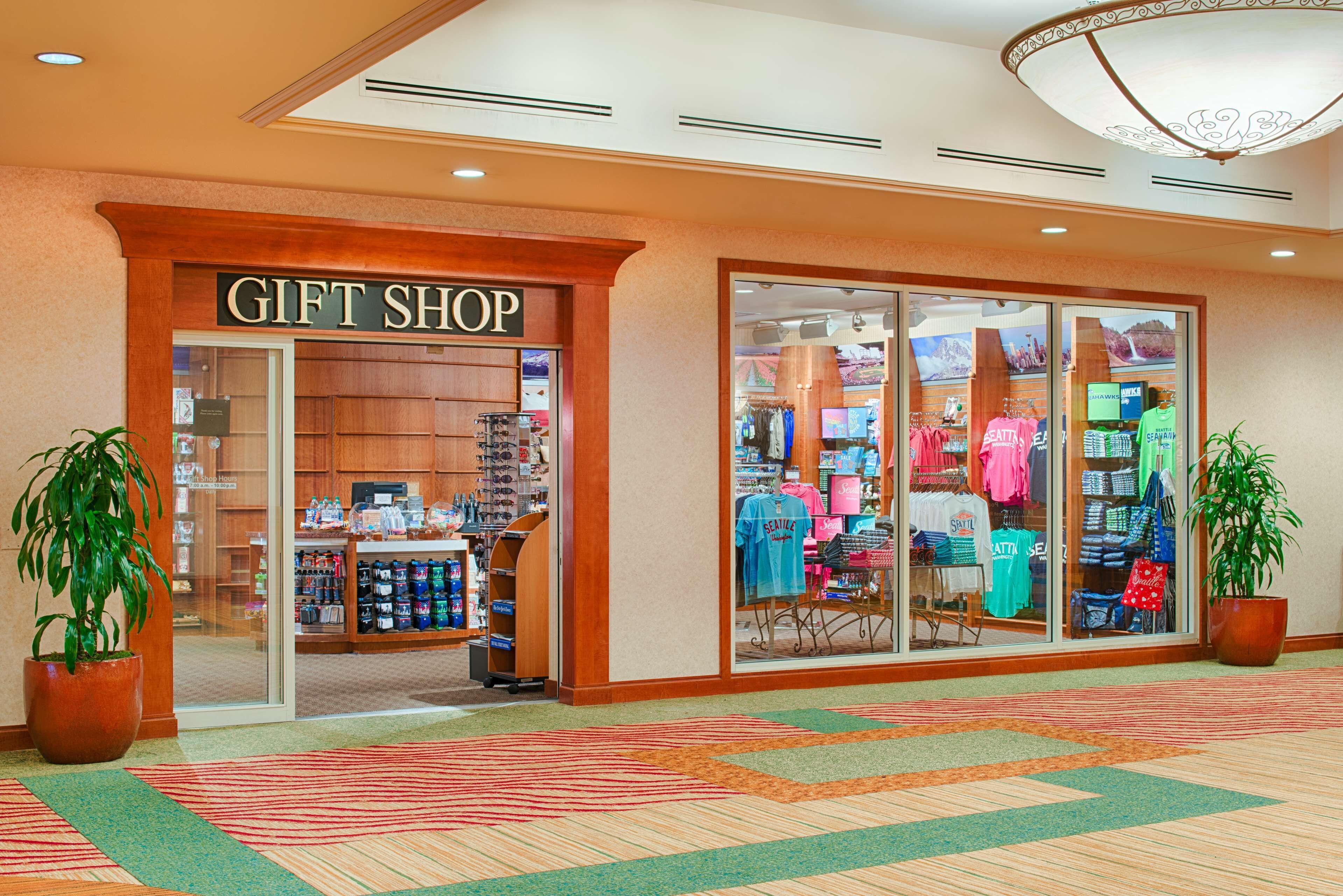 A gift shop with a variety of items on display, including clothing and accessories.
