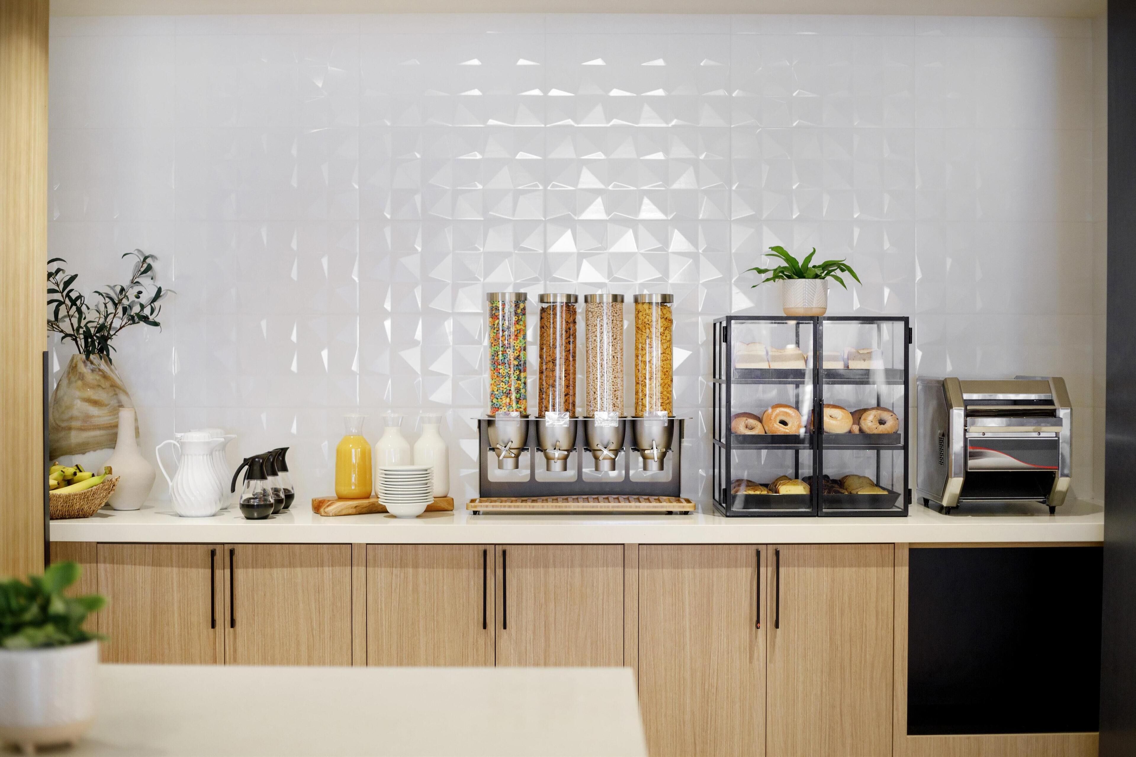 A modern kitchen with a coffee station, a bread display, and a toaster.