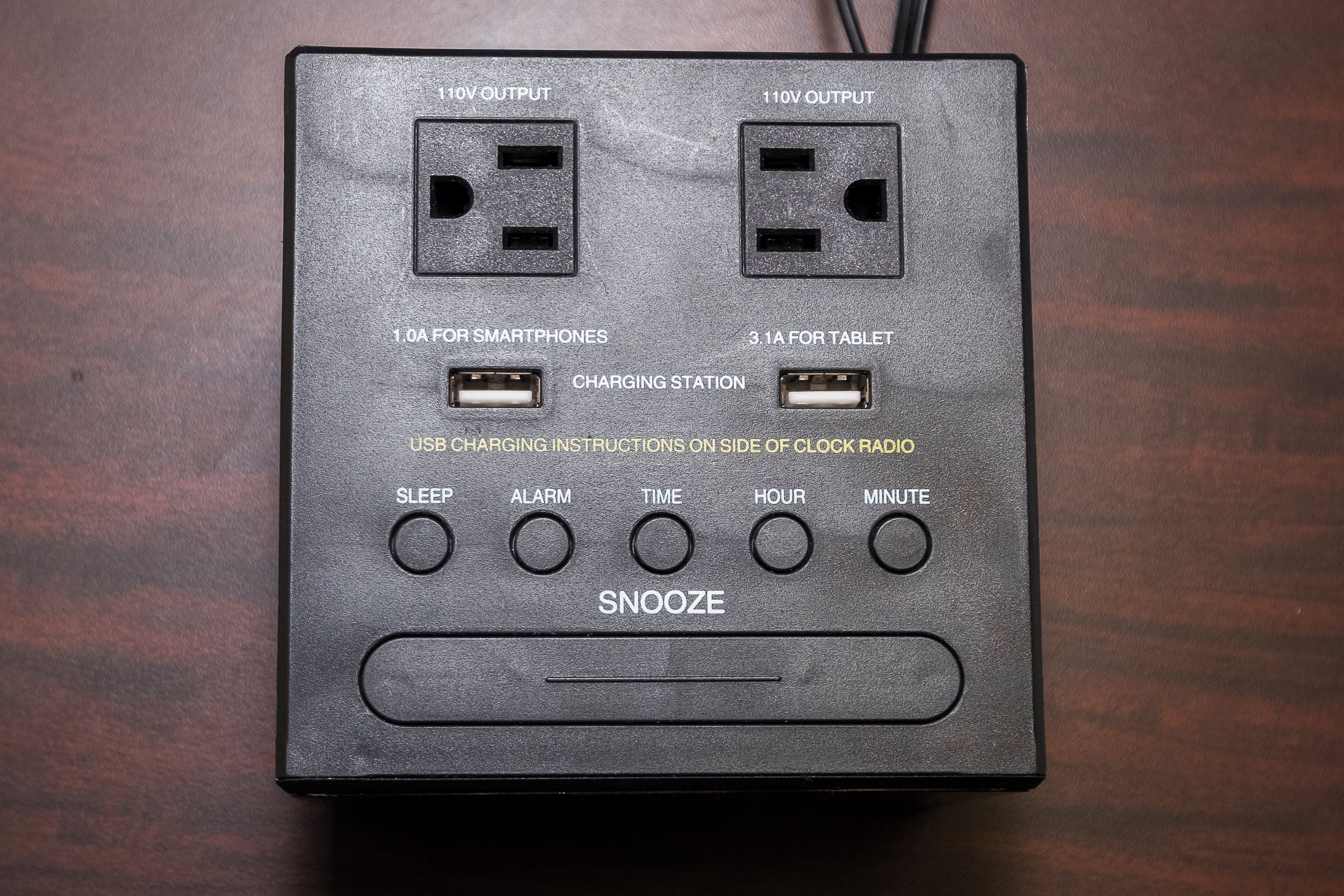 A power strip with multiple outlets and USB ports, including 110V and 120V outputs, and a snooze button.