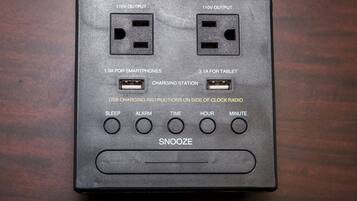 A power strip with multiple outlets and USB ports, including 110V and 120V outputs, and a snooze button.