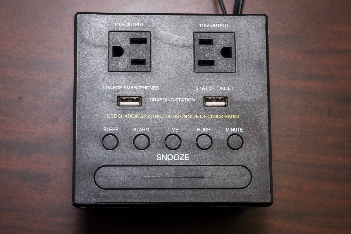 A power strip with multiple outlets, USB ports, and a snooze button.