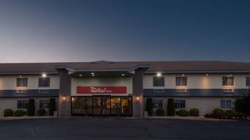 A Red Roof Inn with a modern design, featuring a large entrance and multiple windows.