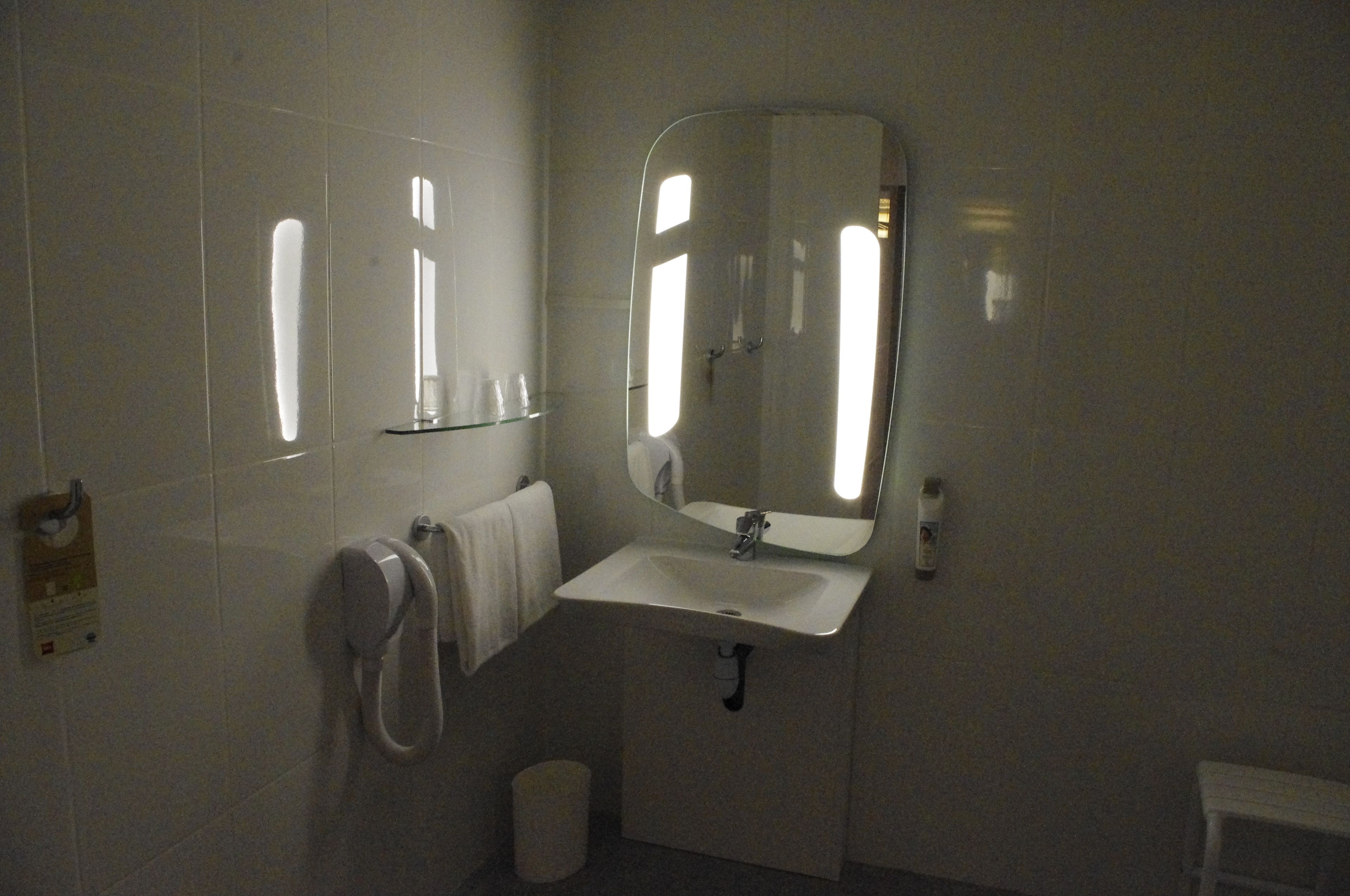 standard double room, multiple beds | bathroom sink