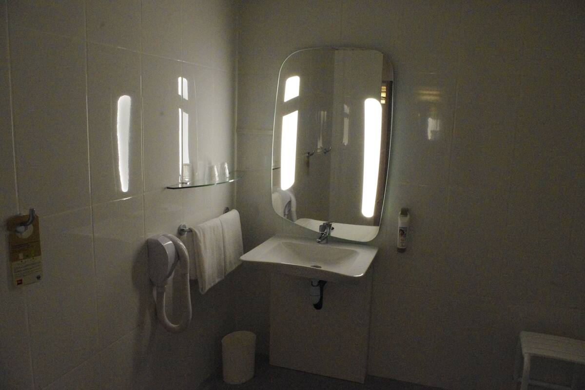 standard double room, multiple beds | bathroom sink