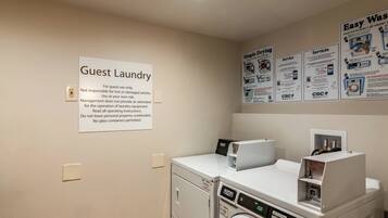A guest laundry area with a sign indicating it's for guest use only, a washing machine, and a dryer.