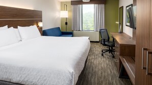 A hotel room with a large bed, a desk, a chair, and a TV. - Holiday Inn Express Atlanta Airport - College Park by IHG (College Park)