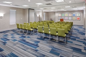 A conference room with rows of chairs, a whiteboard, and a podium. - Holiday Inn Express Atlanta Airport - College Park by IHG (College Park)