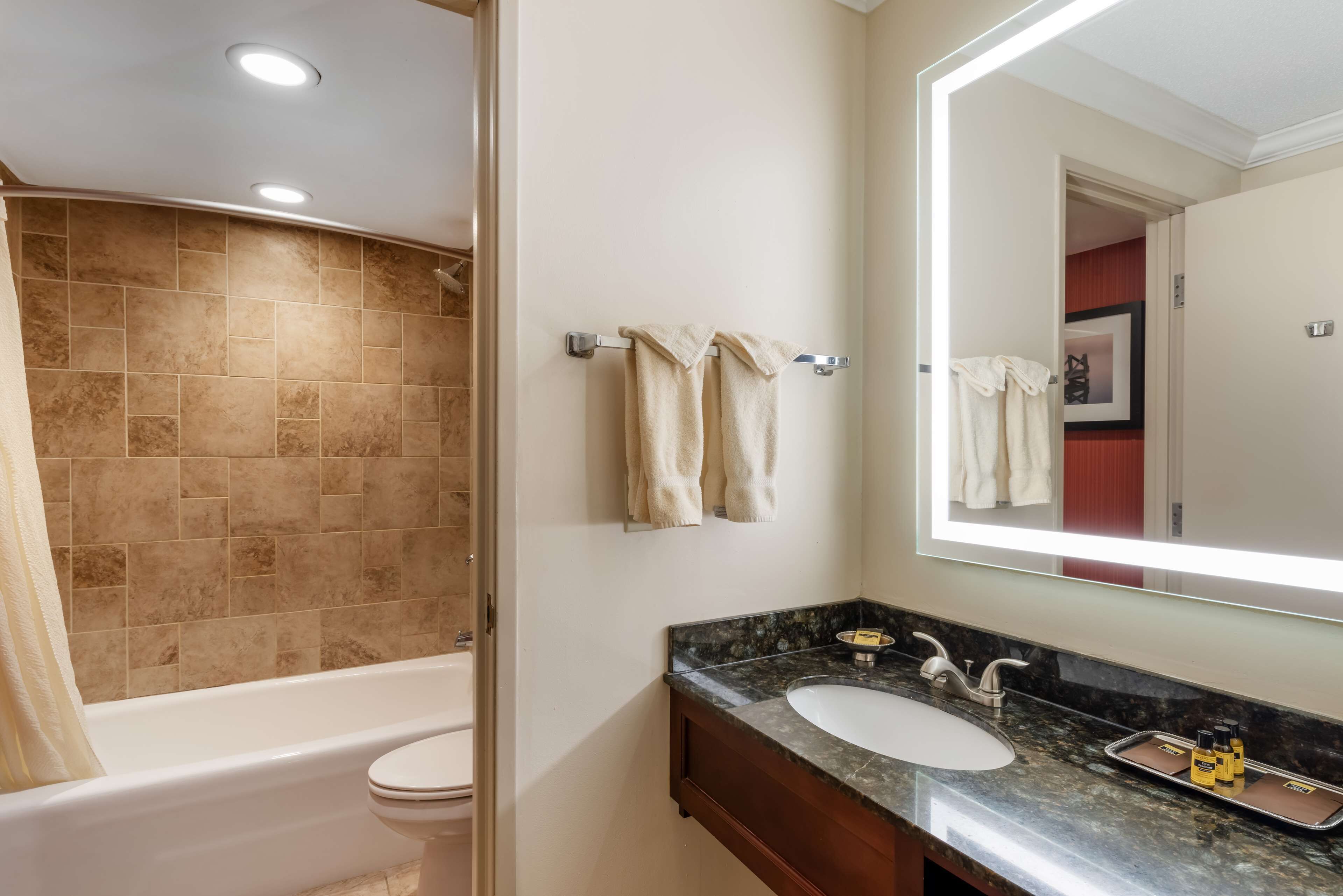 A bathroom with a bathtub, toilet, and sink.