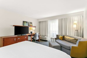 Premium bedding, desk, laptop workspace, blackout curtains