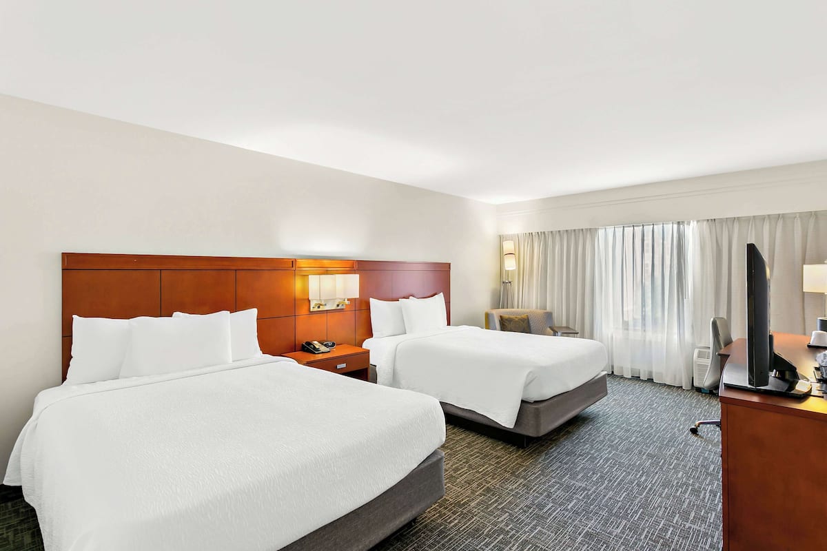 Premium bedding, desk, laptop workspace, blackout drapes