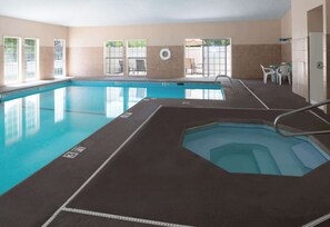 Swimmers can enjoy a refreshing dip in the rectangular pool surrounded by comfortable seating areas.