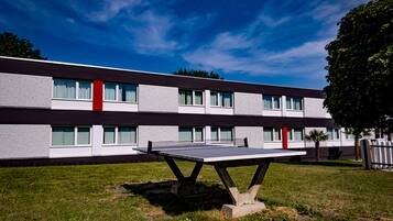 A modern building with a flat roof, large windows, and a flat facade.