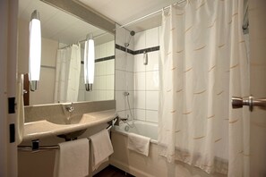 Bathtub, eco-friendly toiletries, hair dryer, towels