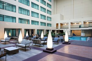 A spacious indoor area with multiple seating arrangements and a pool.