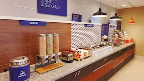 A breakfast buffet area with labeled sections for cereal, hot food, and a Quaker Oatmeal dispenser. - Holiday Inn Express & Suites Pittsburgh West - Greentree by IHG (Pittsburgh)