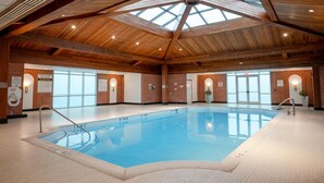 An indoor swimming pool with a wooden ceiling and brick walls. - Sleepy Hollow Hotel, a Dolce by Wyndham (Tarrytown)