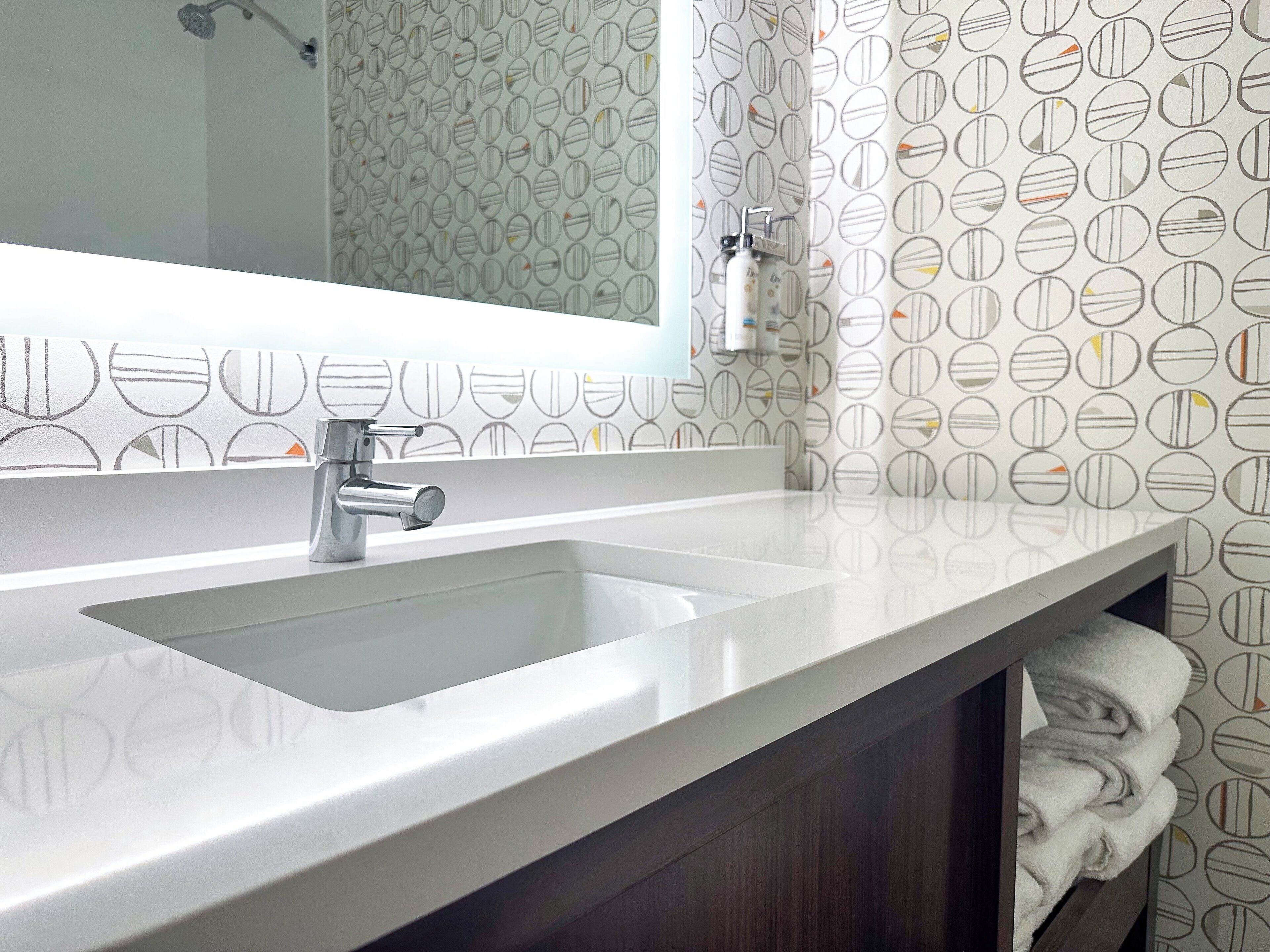 combined shower/bathtub, designer toiletries, hair dryer, towels