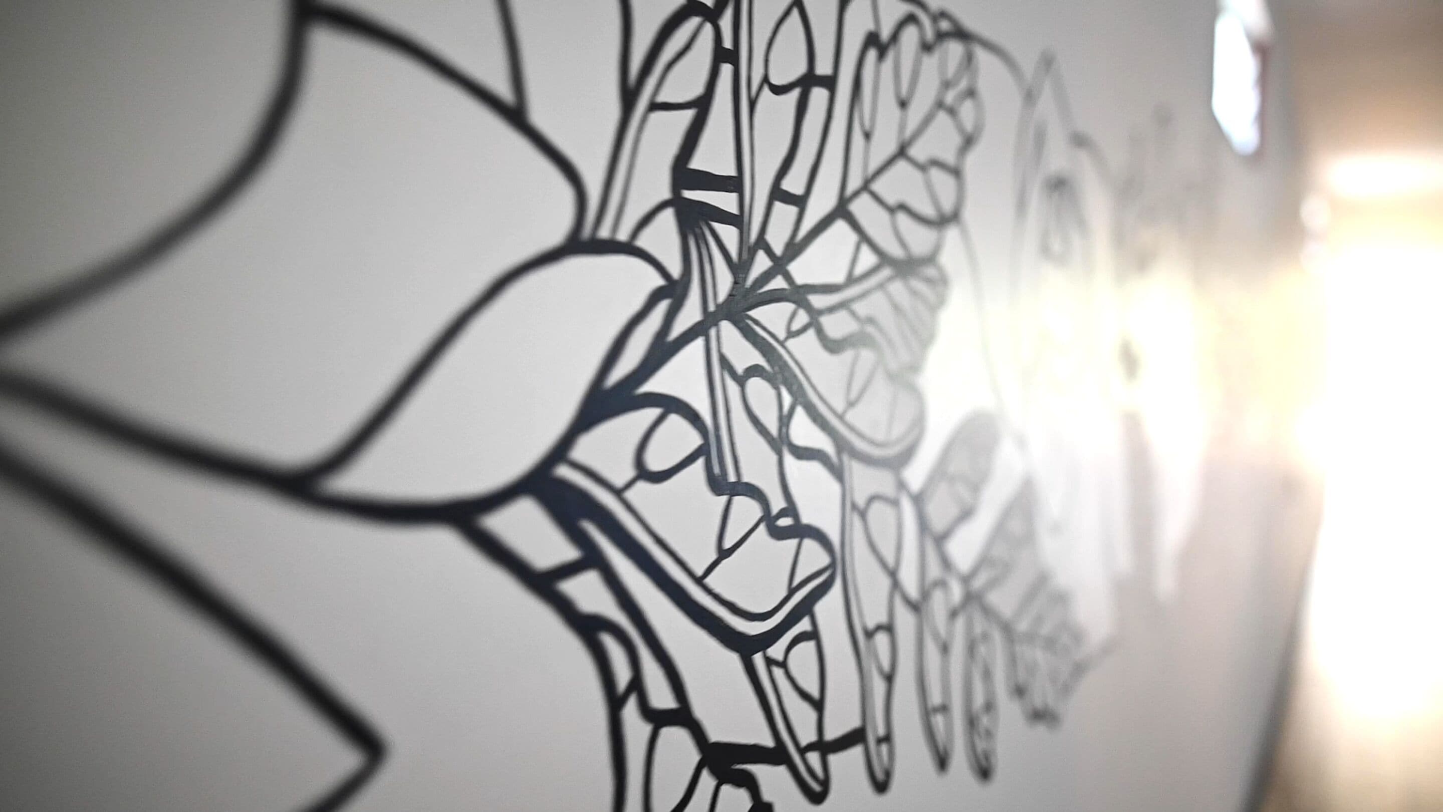 A wall with a complex, abstract line drawing.