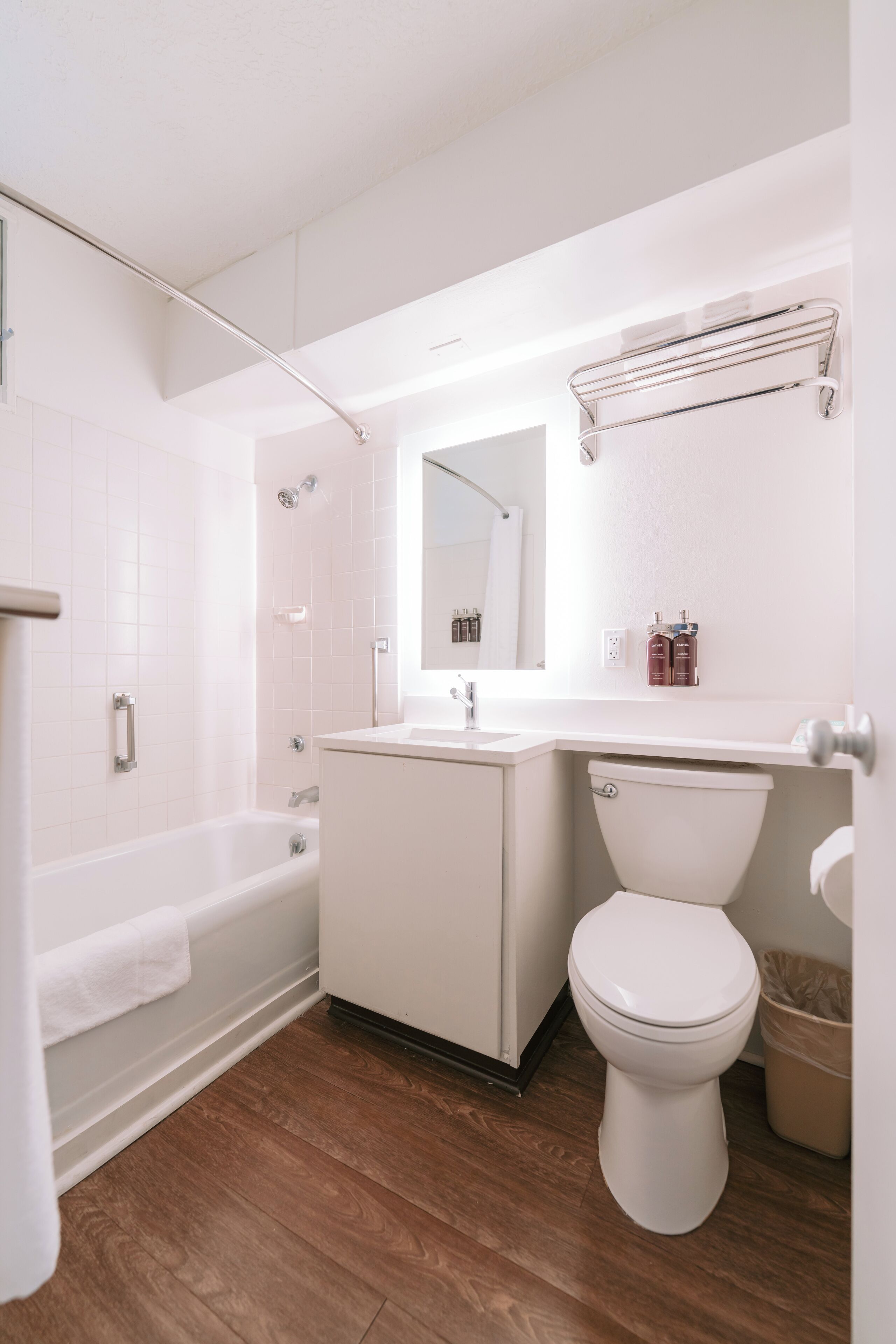 A modern bathroom with a bathtub, toilet, and sink.