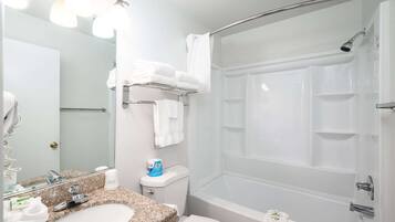 A bathroom with a sink, toilet, and shower.
