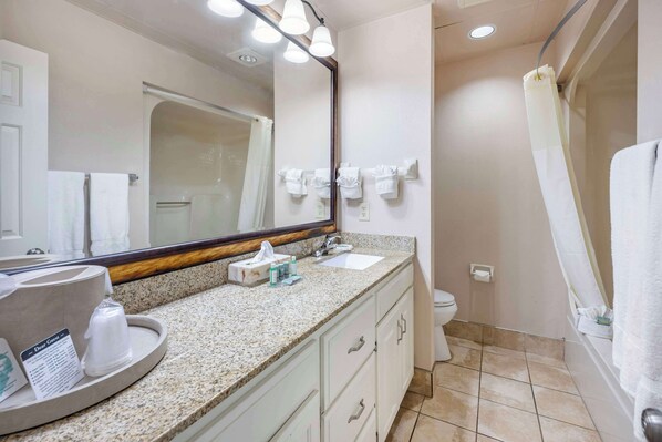 A bathroom with a sink, mirror, towel rack, and shower curtain.