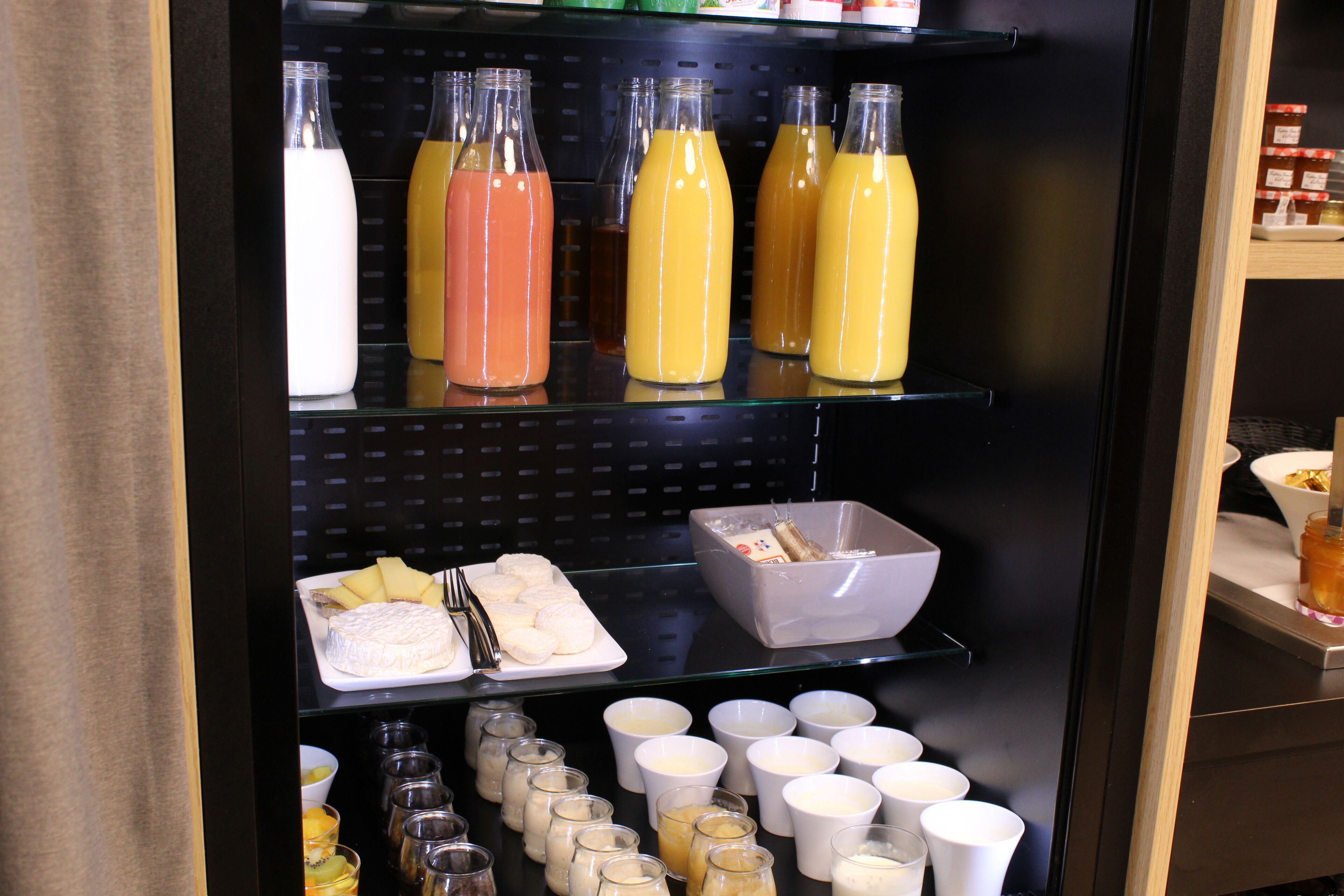 A breakfast buffet with various food items and beverages.