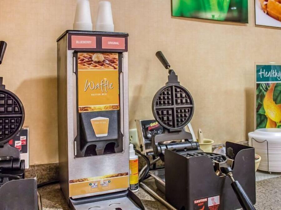 A waffle maker with a label for 'Blueberry Original Batter Mix' and a 'Healthy' sign in the background.