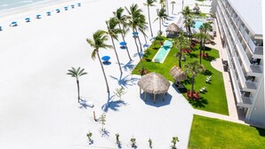 A resort with a beach, palm trees, a pool, and a hotel building. - Best Western Plus Beach Resort (Fort Myers Beach)