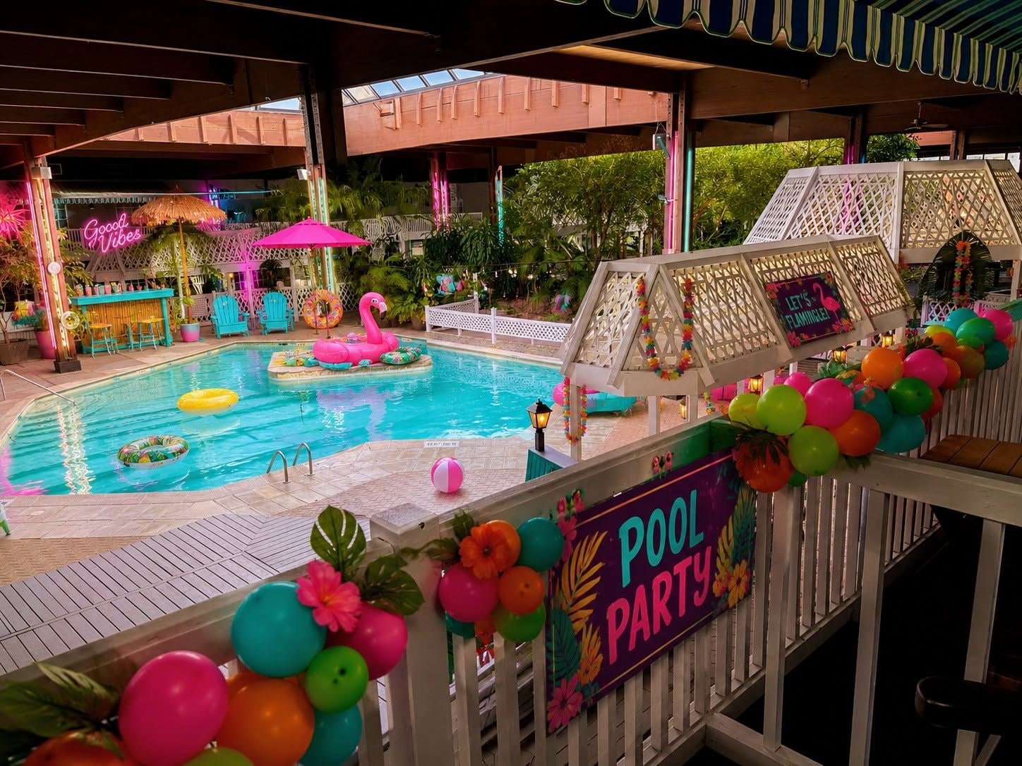 A pool area with a sign indicating a pool party, surrounded by colorful decorations and a tiki bar.