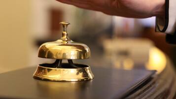 A hand holding a hotel bell.