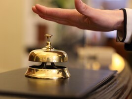 A hand holding a hotel bell.