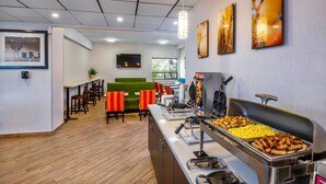 A modern dining area with a buffet, seating arrangements, and artwork on the walls. - Comfort Inn & Suites Barrie - Highway 400 (Barrie)
