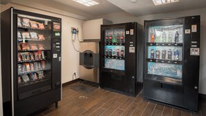 A vending area with snack and drink machines, including a push machine and a cold drink dispenser.