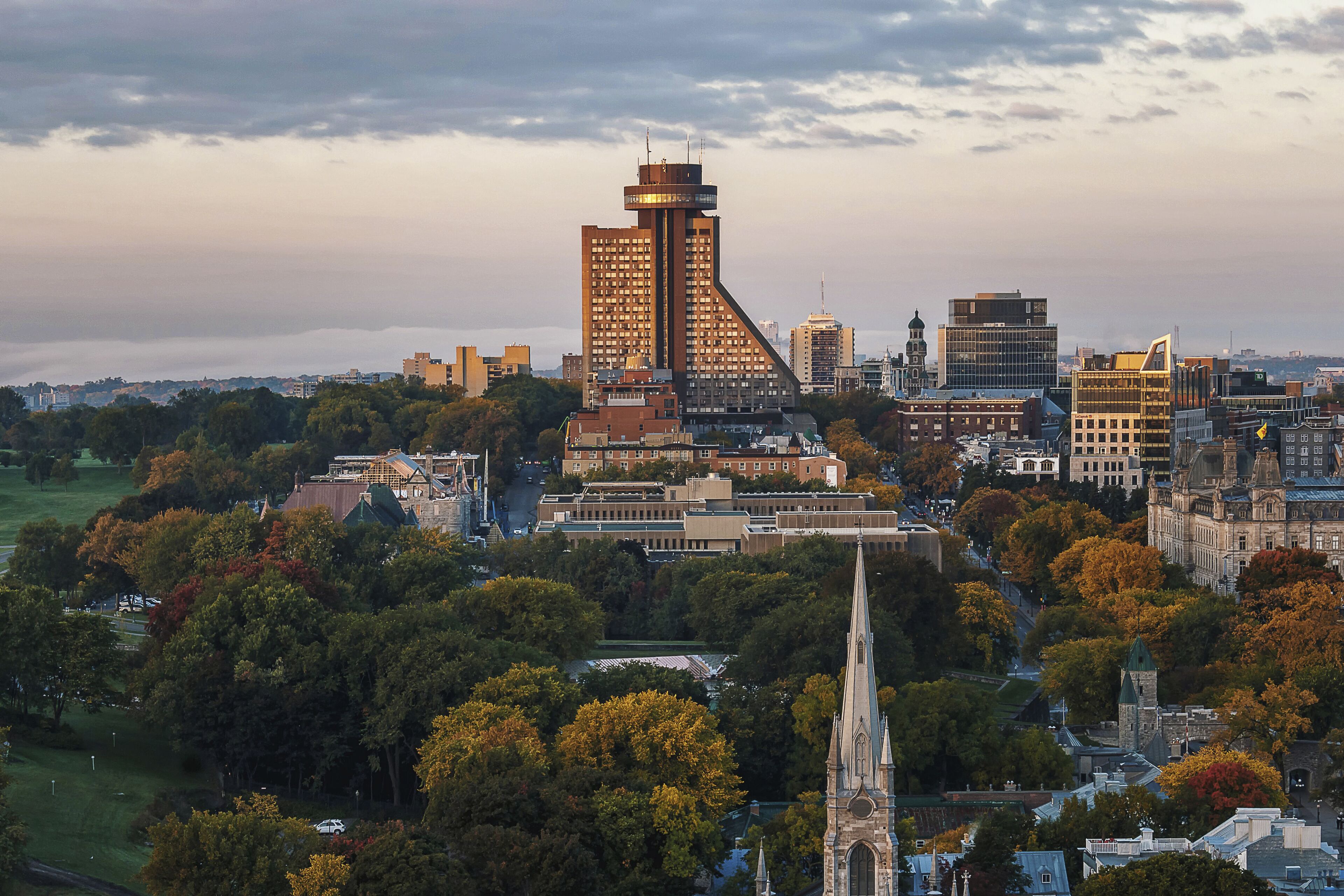 A cityscape with a prominent tower, historic buildings, and a church spire.