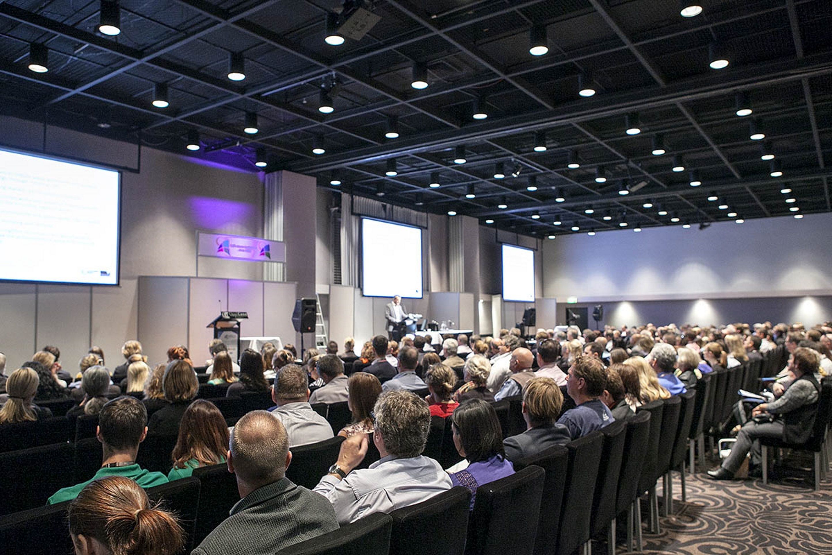 A conference room with rows of chairs facing a presentation area.