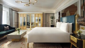 A spacious bedroom with a large bed, a sofa, a bedside table, and a mirror. There is a wardrobe with a mirror, a potted plant, and a chandelier. - Mandarin Oriental Hyde Park, London (London)