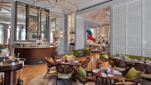 A luxurious restaurant with a bar area, wooden furniture, and a large mirror reflecting the interior. - Mandarin Oriental Hyde Park, London (London)