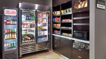 A vending area with Pepsi-Cola and other beverage machines, snack shelves, and a microwave.